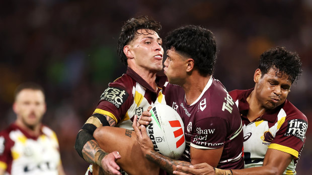 Jordan Riki (left) and Selwyn Cobbo of the Broncos tackle Jaxson Paulo of the Sea Eagles.