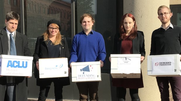 Michael Webermann and Elizabeth Lagesse, first and second from right, join Scott Michelman of the ACLU, far left, to hand in a petition urging the US Attorney's office to drop charges against the accused in the J20 case.