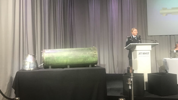 AFP commander Jennifer Hurst shows the missile that allegedly shot down MH17 at a press conference in the Netherlands.