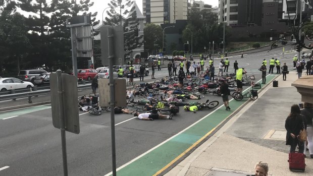 Cyclists stage the "die-in" protest during Brisbane's peak hour traffic.