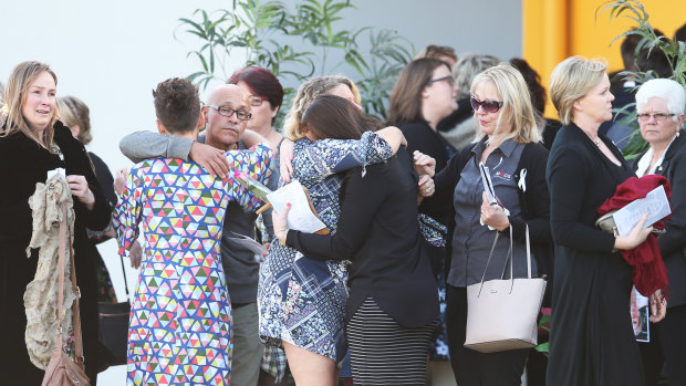 People gather after a memorial service in memory of Samantha Fraser on Phillip Island on Friday.