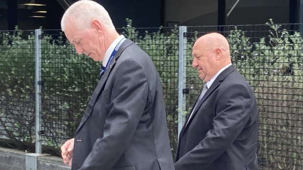 Retired Sergeant Peter Jenkins (right) leaves Toowoomba Magistrates Court on Thursday afternoon.