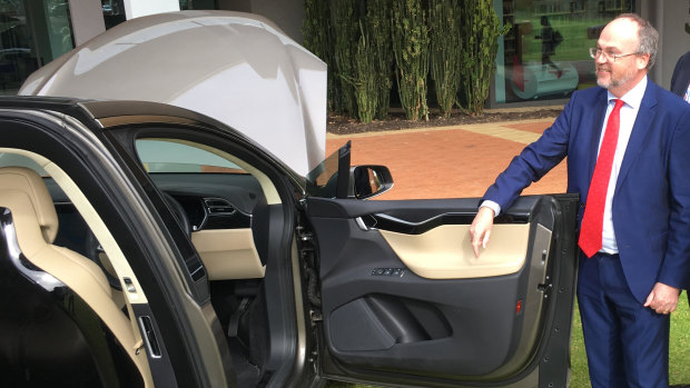 WA Mines and Petroleum Minister Bill Johnston inspecting a Tesla vehicle at a lithium event in May.