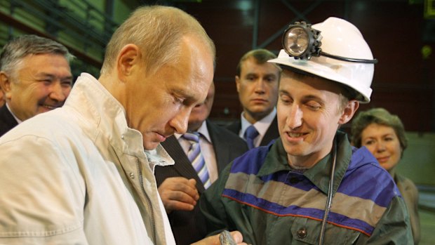 Russian Prime Minister Vladimir Putin examines an uncut chunk of diamond during a visit to Russia’s biggest diamond mine, Mirny, in Siberia in 2009.
