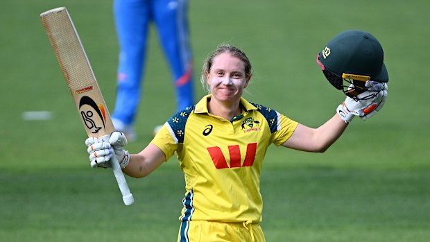 Alyssa Healy of Australia celebrates getting to her century.