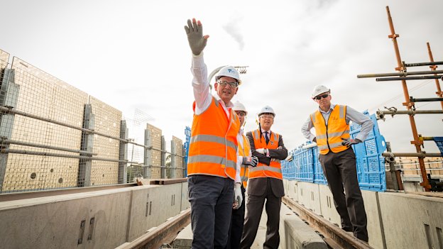 Andrews visits the partly constructed Noble Park "sky rail" overpass in 2018. Tackling the traffic bottlenecks created by rail-and-road intersections this way has been popular with the electorate.  