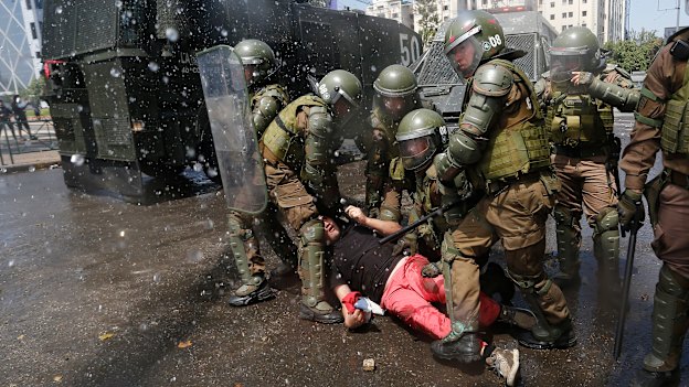 Police subdue a protester on October 20 in Santiago.