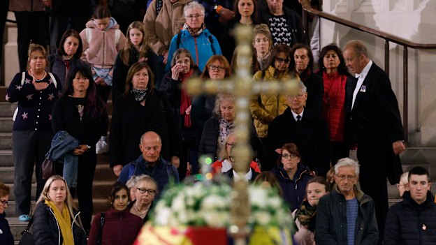 People queue to walk past the coffin of Queen Elizabeth II as it lies in state on the catafalque in Westminster Hall.