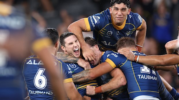 Calm before the storming finish ... Mitchell Moses and the Eels celebrate their golden point win over the Panthers in March.