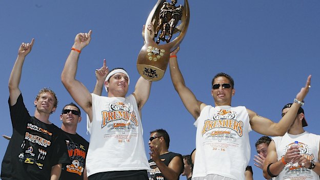 Robbie Farah and Benji Marshall celebrate the 2005 grand final triumph with teammates.