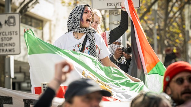 Protesters carrying Palestinian and Iranian flags at a rally in June last year.