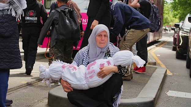 A Melbourne protester at a rally last year holding an effigy intended to symbolise a slain Palestinian child.
