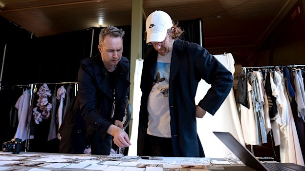 Toni Maticevski (left) and stylist Jolyon Mason look over the running order for the show.