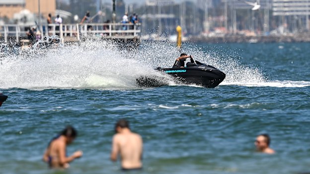 A jet-ski close to swimmers at Port Melbourne on Friday.