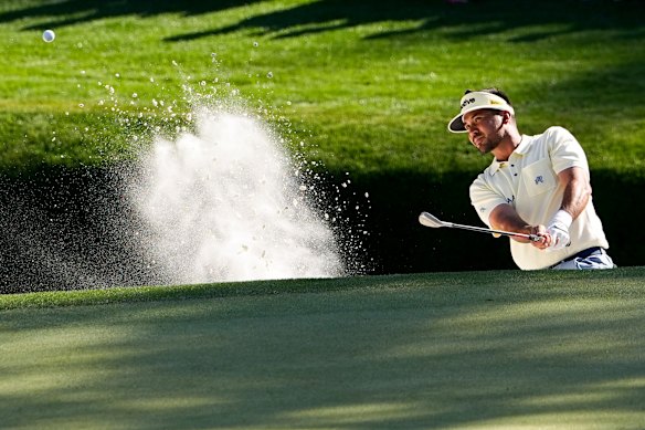 Jason Day escapes from a bunker on 16.