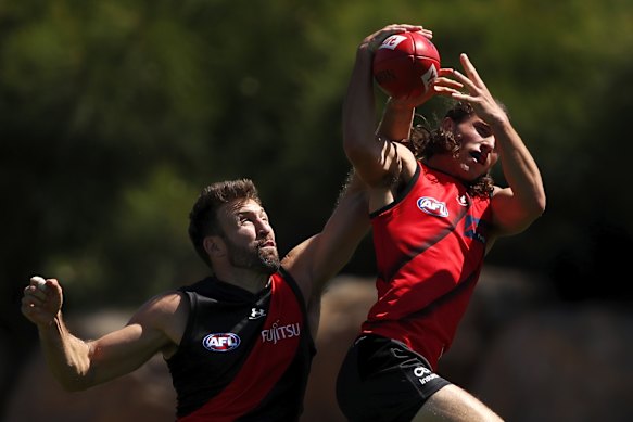 Youngster Archie Perkins goes up against Cale Hooker at training.