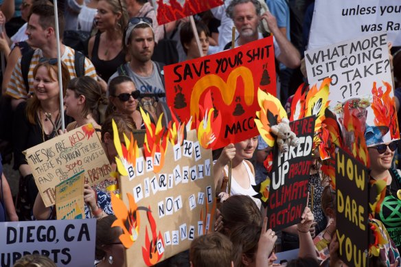 Thousands of protesters rally in front of Sydney Town Hall calling for action on climate change.