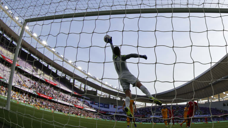 Full flight: Socceroos' goalkeeper Mat Ryan blocks a shot during the Group B opener against Jordan.