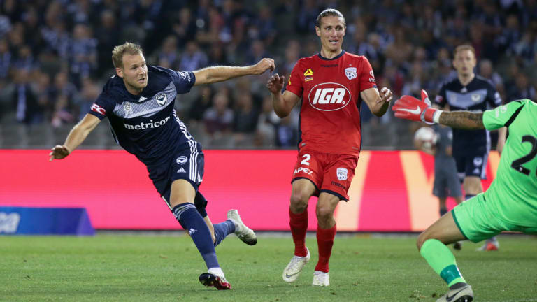 Ola Toivonen of the Victory puts the ball past Adelaide United goalkeeper Paul Izzo.