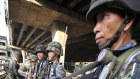 Thai army soldiers face off against government protesters.