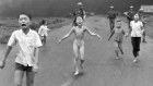 South Vietnamese forces follow after terrified children, including 9-year-old  Kim Phuc, center, as they run down Route 1 near Trang Bang after an aerial napalm attack on suspected Viet Cong hiding places on June 8, 1972.  A South Vietnamese plane accidentally dropped its flaming napalm on South Vietnamese troops and civilians. The terrified girl had ripped off her burning clothes while fleeing. The children from left to right are: Phan Thanh Tam, younger brother of Kim Phuc, who lost an eye, Phan Thanh Phouc, youngest brother of Kim Phuc, Kim Phuc, and Kim’s cousins Ho Van Bon, and Ho Thi Ting.  Behind them are soldiers of the Vietnam Army 25th Division.