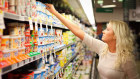 A shopper selects a yoghurt at a Woolworths store. Demand has grown 11 per cent in the past year.