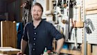 Lawyer Luke Meeve in his garage with his woodwork equipment.