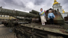 Children stand on top of a burned-out Russian tank in St Michael’s Square in Kyiv.