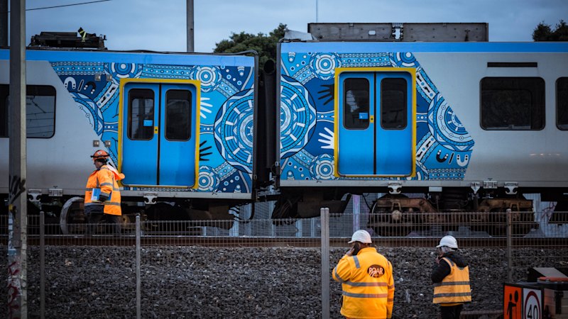 Key train lines remain suspended as a crane arrives to lift carriage derailed at Clifton Hill