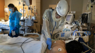 A doctor checks on a COVID-19 patient at a hospital in Los Angeles.