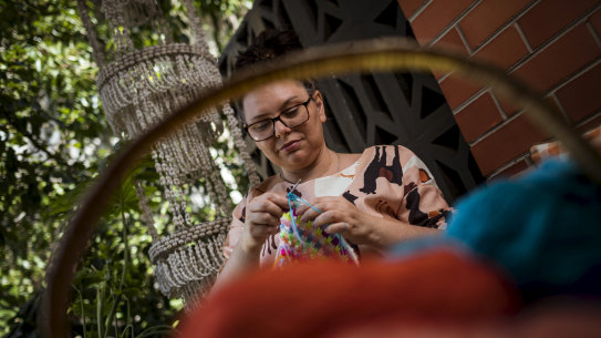 Pip Lincolne knits in the fresh air outside her Balwyn home.