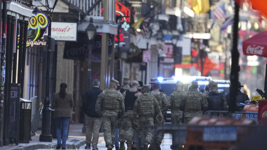Military personnel walk down Bourbon street on Thursday in New Orleans.