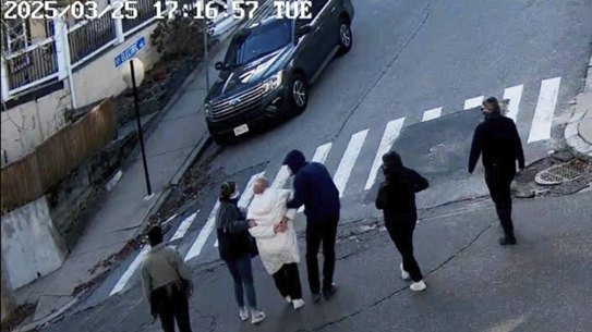 In this image taken from security footage, Rumeysa Ozturk, a 30-year-old doctoral student at Tufts University, is detained by Department of Homeland Security agents on a street in Sommerville, Massachusetts.