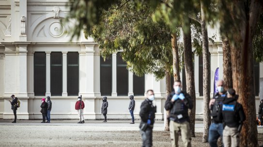 Long lines for the Covid-19 vaccination at the Carlton Exhibition Building amid a heavy police presence after an Anti-Vax protest failed to eventuate.