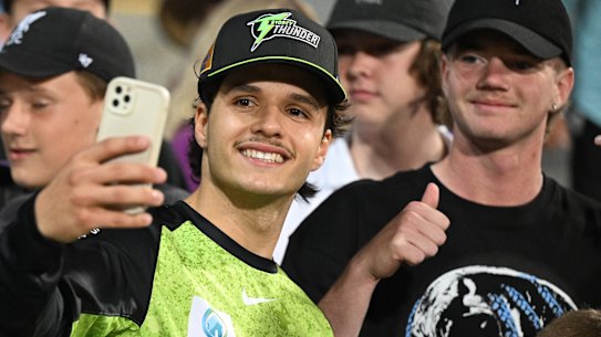 Sam Konstas, in BBL mode, poses for a selfie with a fan.