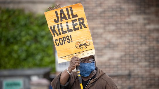 Steven Hudson protests near the site where a black man, who was taken into police custody the day before, later died. 
