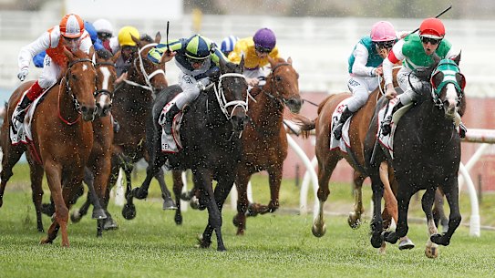 Damian Lane rides Mer De Glace, right, to victory at the 2019 Caulfield Cup. 