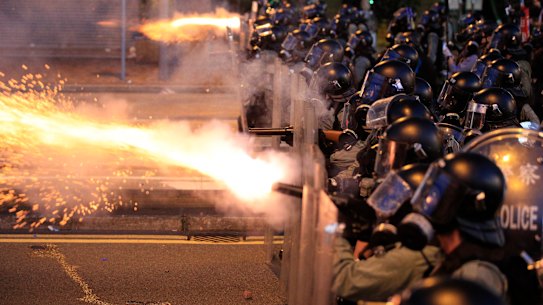 Hong Kong police fire tear gas at protesters in Sai Wan on Sunday night.