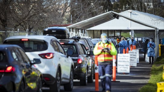 Long lines of people wait to get their COVID-19 test in Melbourne.