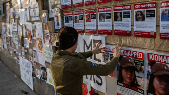 An Israeli soldier posts a photograph of a hostage in Tel Aviv, Israel.
