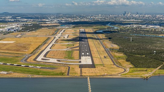 The new stretch of tarmac will be Brisbane Airport's third runway, but an existing one (bottom left) has been clogged by parked Virgin Australia aircraft in recent months.