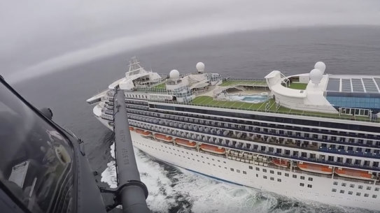 The California National Guard has winched supplies, including coronavirus test kits, down to the Grand Princess.