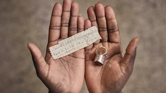 A Mauritanian migrant who crossed the US southern border shows the address of a Manhattan shelter he kept in the compartment of a ring during his journey.