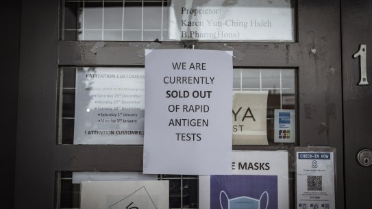 A sign posted to the door of a pharmacy on Nicholson Street in Carlton informs customers it has sold out of rapid antigen tests.