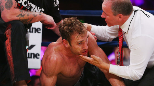 Shane Tuck on the ground after being knocked out during a boxing match after his retirement from AFL.