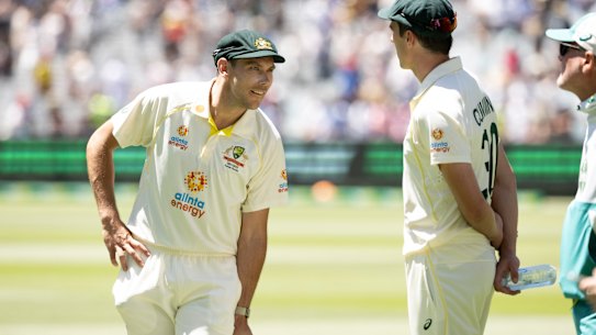 28/12/21 The Australian captain Pat Cummins and man of the match Scott Boland on day 3 of the Boxing Day test match at the MCG between Australia and England in the 2021/22 Ashes. Photograph by Chris Hopkins