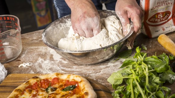 Mariano De Giacomi mixes his dough one-handed.