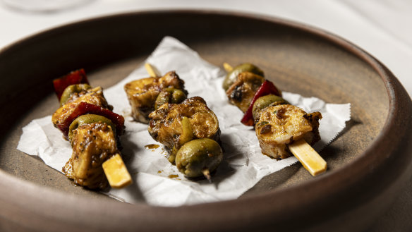 Octopus skewers with ’nduja, green olives and red peppers.