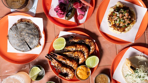 Clockwise from left: Mulita (two blue-corn tortillas sandwiched with chorizo and cheese), pickles, brisket costra taco, fish taco and prawns zarandeados at Taqueria Sin Nombre.