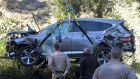 A crane is used to lift a vehicle following a rollover accident involving golfer Tiger Woods in the Rancho Palos Verdes suburb of Los Angeles. 